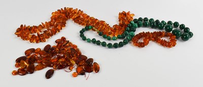 Lot 258 - An amber polished rough cut beaded necklace,...