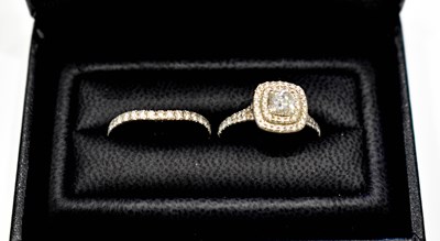 Lot 166 - A platinum and diamond double halo ring, the...