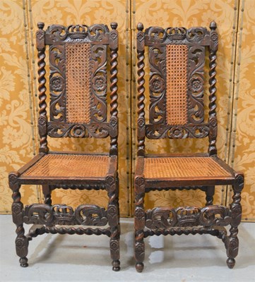 Lot 641 - A pair of Carolean walnut hall chairs carved...