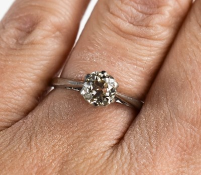 Lot 13 - A diamond and platinum solitaire ring, the...