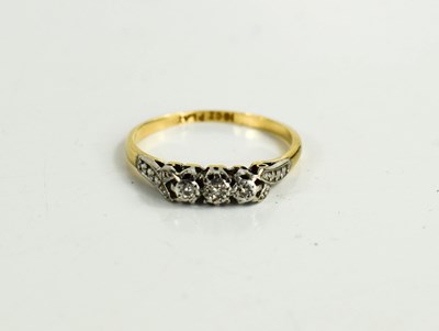 Lot 64 - A 9ct gold and illusion set diamond three...