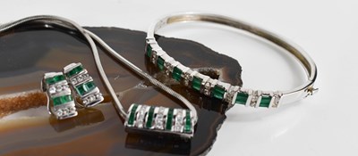 Lot 6 - A 14ct white gold, diamond and emerald demi...