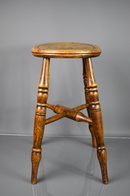 Lot 632 - An early 19th century oak stool with circular...