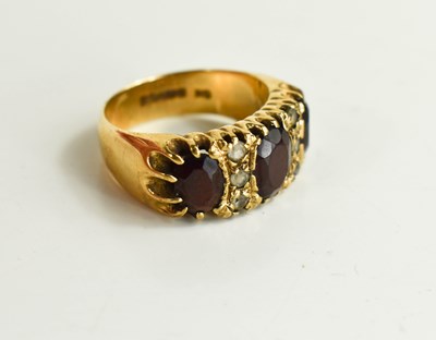 Lot 31 - A vintage 9ct gold garnet dress ring the three...