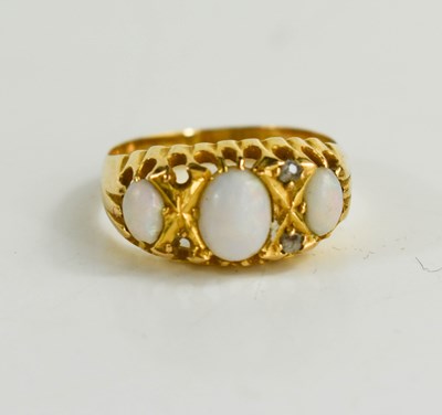 Lot 79 - An 18ct gold opal and diamond dress ring with...