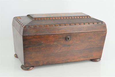 Lot 293 - An antique rosewood tea caddy raised on bun feet