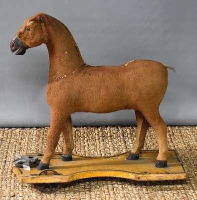 Lot 287 - A Victorian child's pull-along horse, clad...