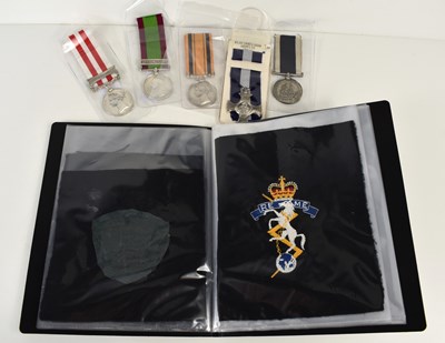 Lot 64 - A group of medals and military cloth badges to...