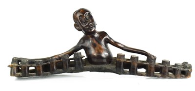 Lot 347 - An African carved figure of a boy playing the...