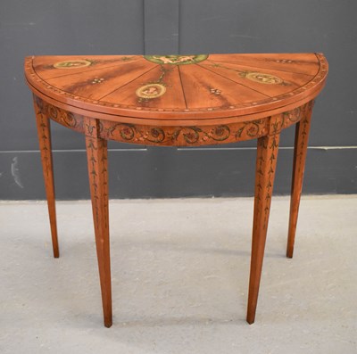 Lot 516 - A 19th century satinwood painted demi-lune...
