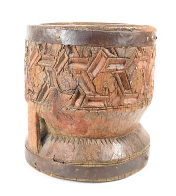 Lot 446 - An African carved hardwood mortar with iron...
