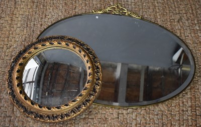 Lot 494 - An early 20th century brass framed oval mirror...