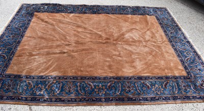 Lot 519 - An Indian wool carpet, in mustard brown with...