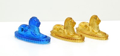 Lot 17 - A pair of Victorian amber glass lions, in...