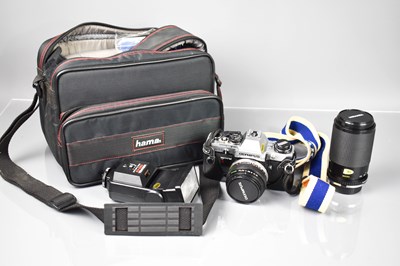 Lot 588 - An Olympus CM10 35mm camera and flash in a...