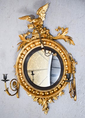 Lot 541 - A Regency convex mirror with scrolling arm...