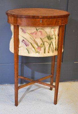 Lot 563 - A 19th century satinwood oval sewing table,...