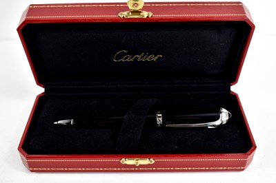 Lot 302 - A Cartier ballpoint pen, black composite body...