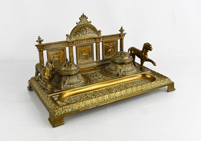 Lot 411 - An Edwardian brass desk stand, cast with face...