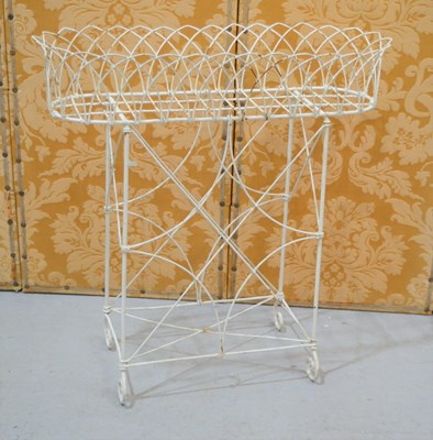 Lot 510 - A cream painted wirework plant stand, 74 by 30...