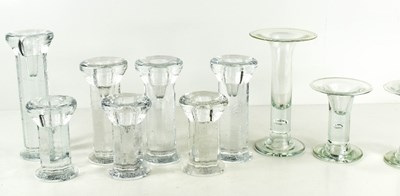 Lot 33 - A group of Kosta Boda clear glass candlesticks,...
