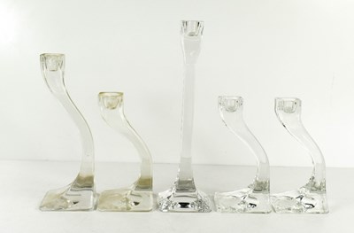 Lot 34 - Five clear glass 'Connect' candlesticks, the...