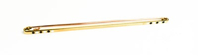 Lot 67 - A 14k gold and enamel bar brooch, the machine...