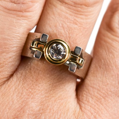 Lot 26 - An 18ct bi-coloured gold and diamond ring by...