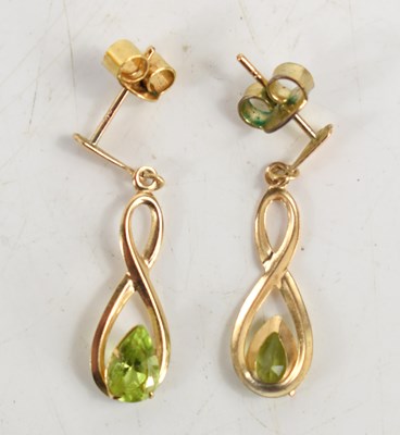Lot 197 - A pair of 9ct gold and peridot drop earrings.