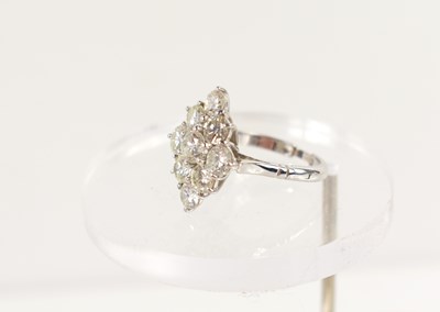 Lot 18 - A white gold and diamond ring set with nine...