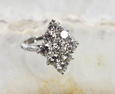 Lot 18 - A white gold and diamond ring set with nine...