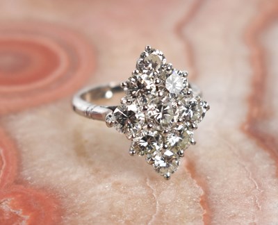 Lot 18 - A white gold and diamond ring set with nine...