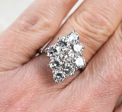 Lot 18 - A white gold and diamond ring set with nine...