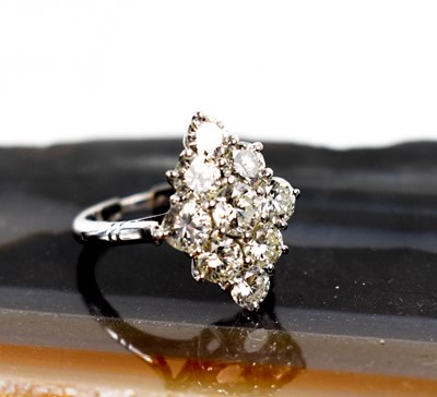Lot 18 - A white gold and diamond ring set with nine...
