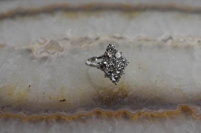 Lot 18 - A white gold and diamond ring set with nine...