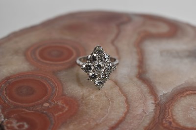 Lot 18 - A white gold and diamond ring set with nine...