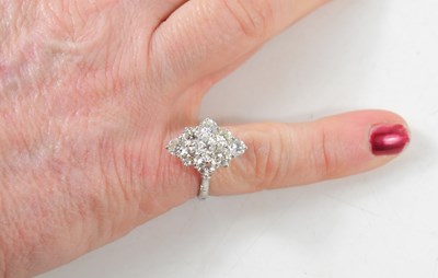 Lot 18 - A white gold and diamond ring set with nine...