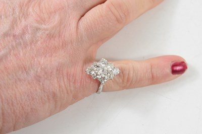 Lot 18 - A white gold and diamond ring set with nine...