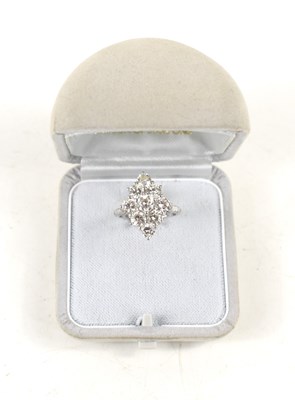 Lot 18 - A white gold and diamond ring set with nine...