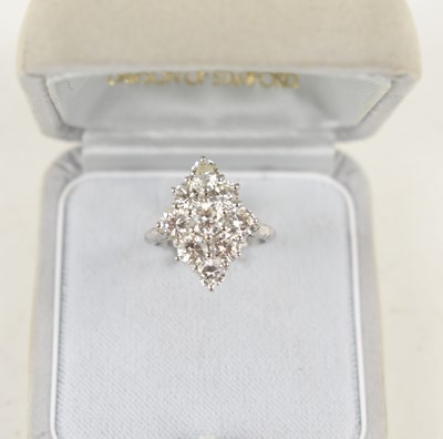 Lot 18 - A white gold and diamond ring set with nine...
