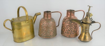 Lot 497 - A Three Islamic brass and copper jugs together...