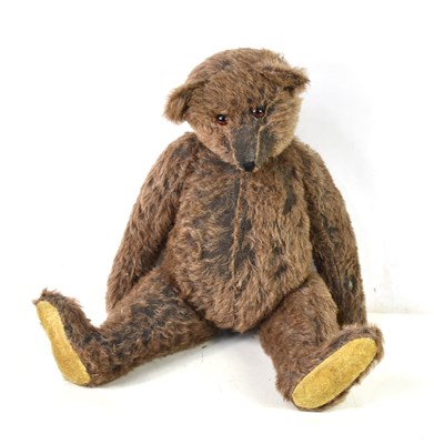 Lot 415 - A straw filled teddy bear, in the style of...
