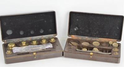 Lot 254 - Two sets of apothecary weights by Baird &...