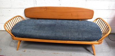 Lot 556 - A Mid-Century Ercol elm and beech studio couch...