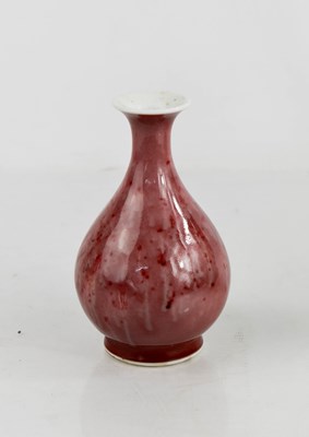 Lot 412 - A small Chinese red mottled glazed baluster...