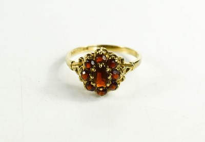Lot 69 - A 9ct gold and flame red stone cluster ring,...