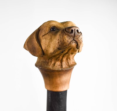 Lot 303 - A treen walking cane, the handle carved in the...