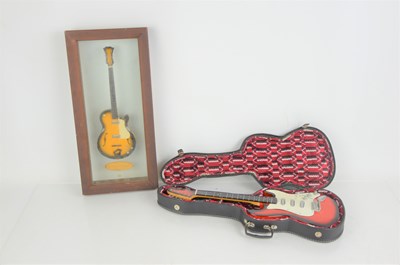 Lot 240 - Two miniature collectible guitars, one in case...