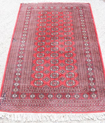 Lot 460 - A Middle Eastern red ground rug, with central...