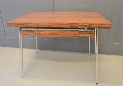 Lot 589 - A Modernist extending dining table by...